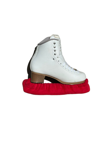 A pair of Skating Eleganza Terry Soakers in soft terry cloth fabric, shown covering skate blades to prevent rust and damage. Red.